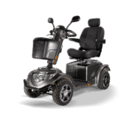 Scooterpac Ignite Mini mobility scooter three-quarter view showing gray finish, padded seat, and rugged tires