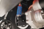 Scooterpac Savvy 4 mobility scooter rear wheel suspension detail with blue shock absorber