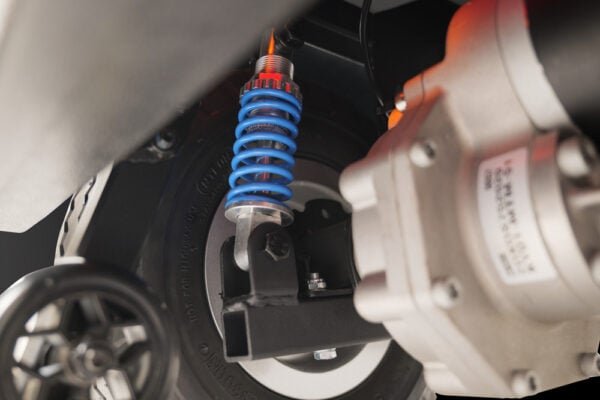 Scooterpac Savvy 4 mobility scooter rear wheel suspension detail with blue shock absorber