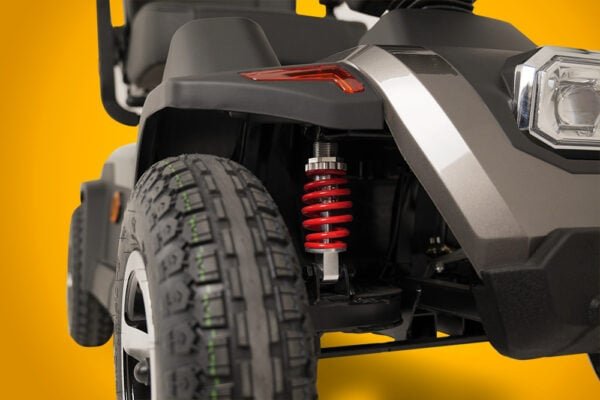Scooterpac Savvy 8 Plus mobility scooter wheel and red suspension detail view