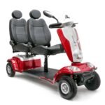 Scooterpac Tandem two-person mobility scooter in red, side angle view showing dual grey seats