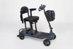 Monarch Genie ultralight mobility scooter three-quarter view showing black seat, basket, and compact 4-wheel design
