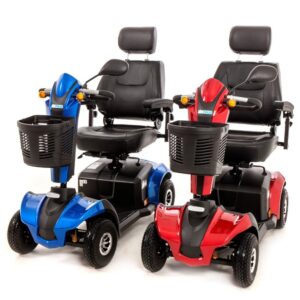 Two MM4 Class 2 mobility scooters in blue and red, three-quarter front view showing padded seats and front baskets