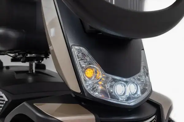 Storm Class 3 mobility scooter front headlight detail with LED indicators and clear lens housing