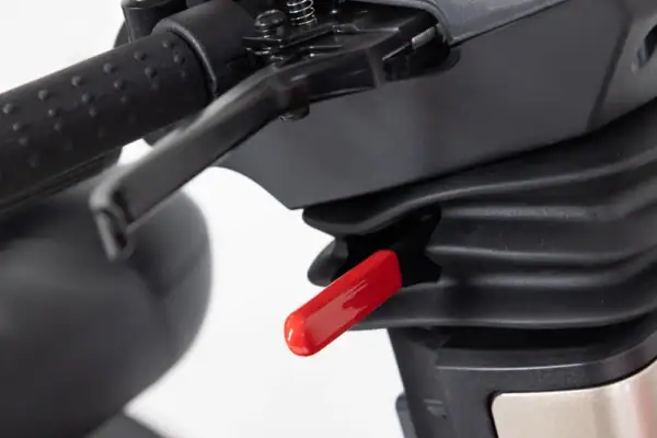 Storm+ mobility scooter detail view showing red safety release button and black steering mechanism
