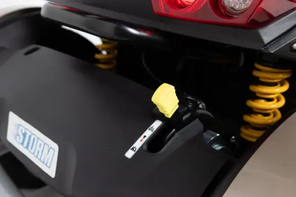 Storm+ mobility scooter rear detail showing yellow suspension springs and charging port