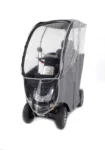 Storm+ Class 3 mobility scooter with clear hard canopy, front three-quarter view showing enclosed cabin