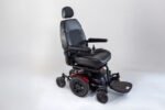 Monarch Super Powerchair in black leather, three-quarter view showing adjustable seat, armrests and footrests