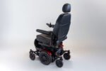 Monarch Super Powerchair in black leather, three-quarter rear view showing adjustable headrest and seat positioning