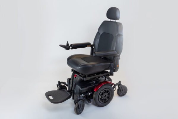 Monarch Super Powerchair in black leather, three-quarter front view showing joystick control and footrests