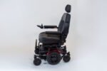 Monarch Super Powerchair side profile view showing black leather seat, headrest, and joystick control