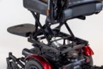 Merits Monarch Super Powerchair detail view showing scissor lift seat mechanism and red wheel fenders