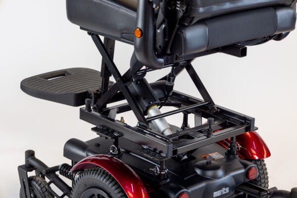Merits Monarch Super Powerchair detail view showing scissor lift seat mechanism and red wheel fenders