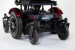 Merits Monarch Super Powerchair rear three-quarter view showing red fenders, robust tires and suspension system