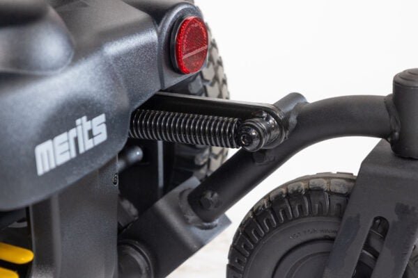Merits Monarch Super Powerchair rear suspension detail showing shock absorber and red reflector