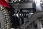 Monarch Super Powerchair rear suspension detail view showing black coil spring shock absorber system