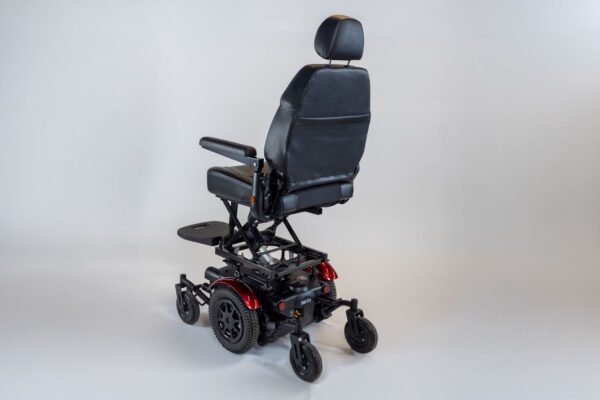 Monarch Super Powerchair in black leather, three-quarter rear view showing elevated seat position and red wheel accents
